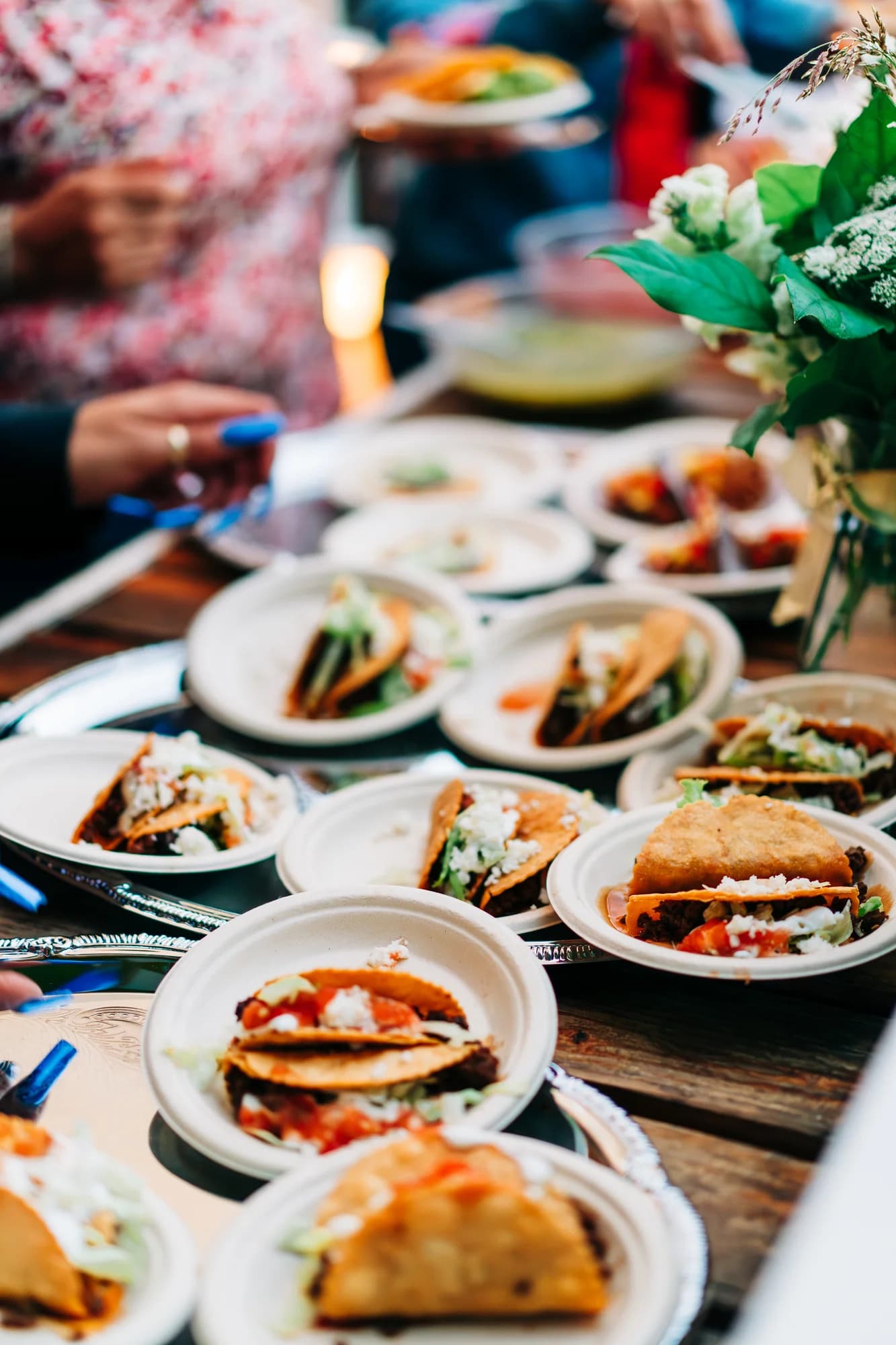 Rows of mini street tacos topped with cotija, salsa, and lettuce served on small plates at a Darling Aviary private event on K Street in Sacramento